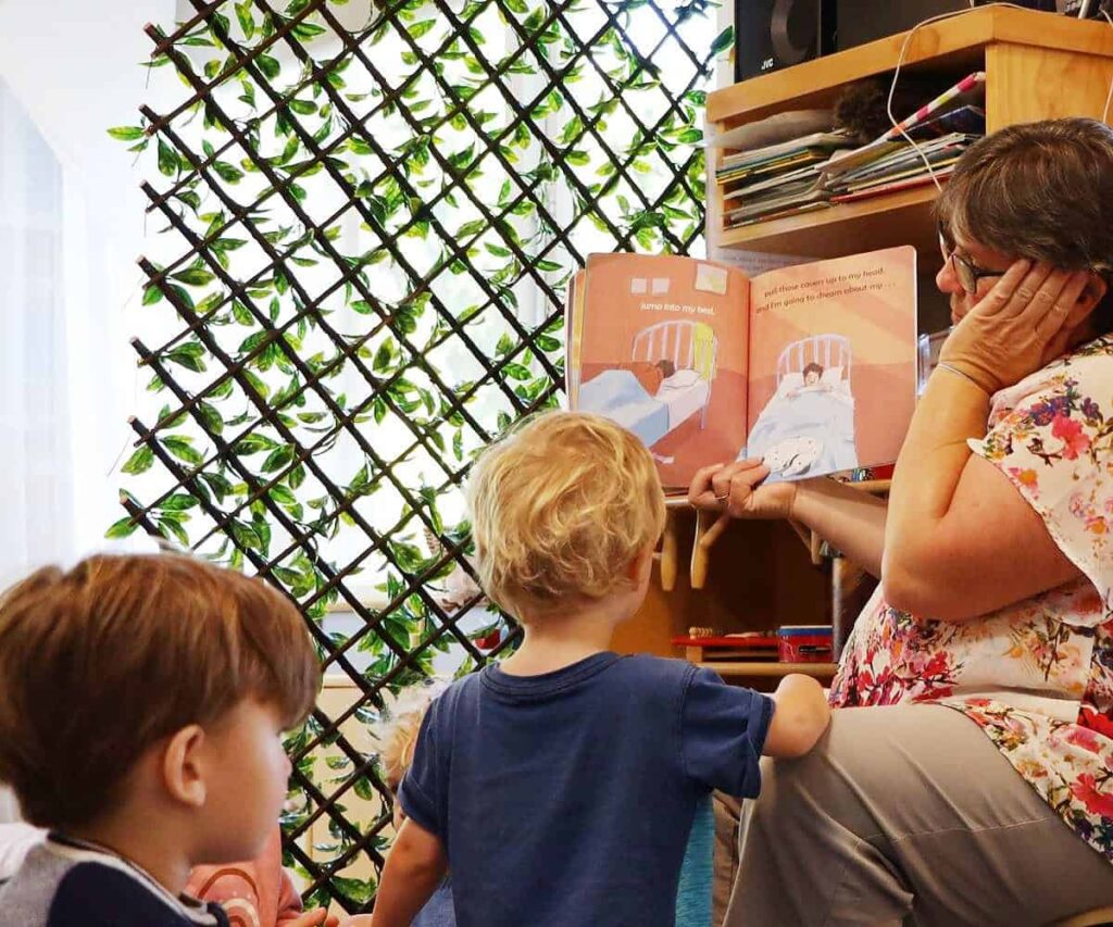 teacher reading book to a group of children