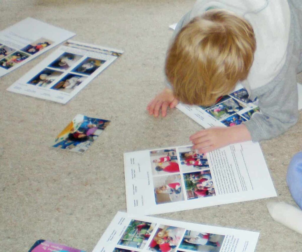 child shares a learning story assessment and his portfolio with a friend